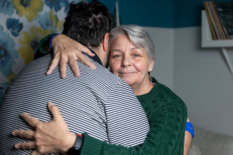 Carolyn Piro of Cherry Hill poses for a portrait with her son Sean Curran, who has autism, in their home last week. Piro took her family on a cruise and they were asked to leave after an incident involving Curran, which she says showed a lack of awareness about people with autism.