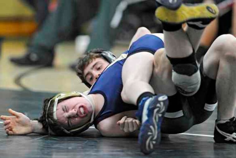 Collingswood's Donnie Daley grimaces as he tries to avoid being pinned by West Deptford's Evan Zuzulock in the 112-pound weight class. Daley was pinned by Zuzulock.
