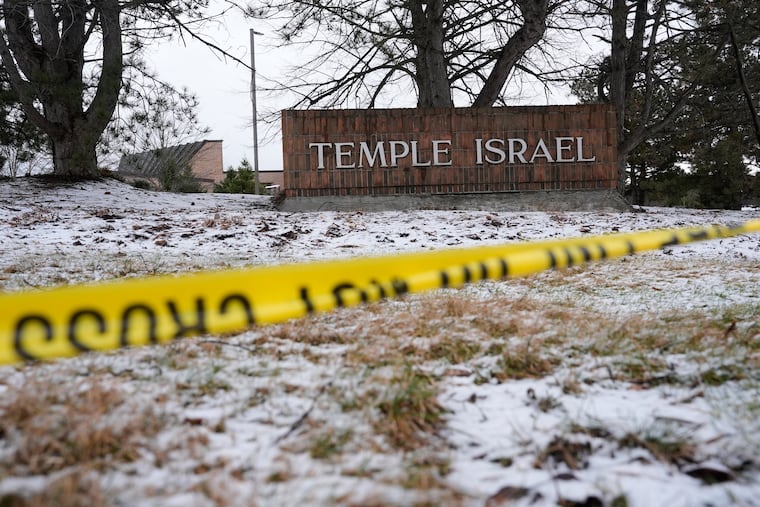 Police tape hangs outside the Temple Israel synagogue Friday, March 13, 2026, in West Bloomfield Township, Mich.