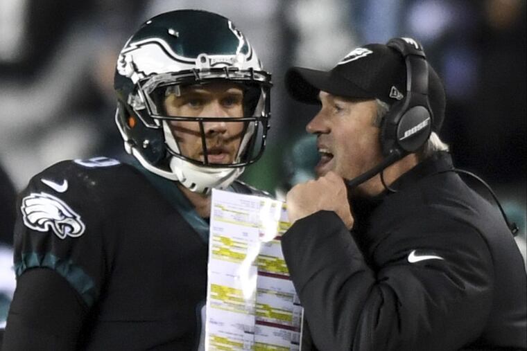 Eagles coach Doug Pederson and quarterback Nick Foles talk late in the fourth quarter Monday night.
