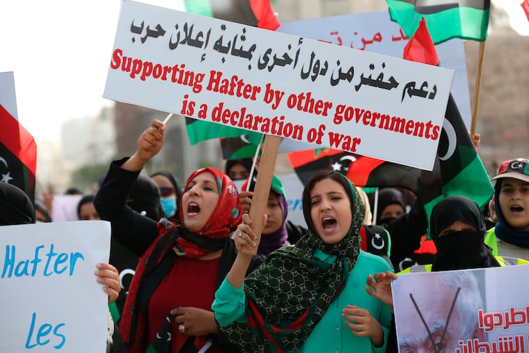 Protesters chant slogans against military operations by Field Marshal Khalifa Hifter's forces in Martyrs' Square on in Tripoli, Libya on Friday, April 26, 2019. Libya’s U.N.-supported government has asked the Security Council to appoint a “fact-finding mission” to investigate alleged violations by the forces attacking the capital, according to a letter circulated Thursday.