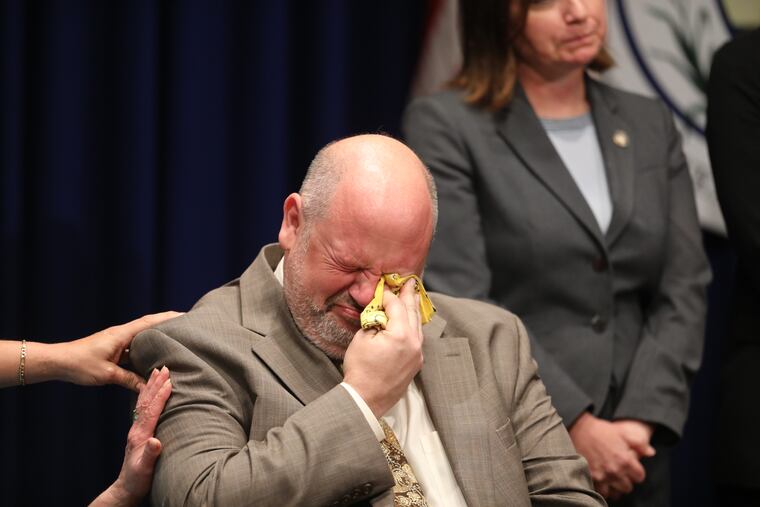 Unidentified victims and families and sexual abuse victims sit on the stage as Pennsylvania Attorney General Josh Shapiro releases the findings of a two-year grand jury investigation into clergy abuse at six of the state's Roman Catholic Dioceses, leading a news conference at the Capitol in Harrisburg on Aug. 14, 2018.