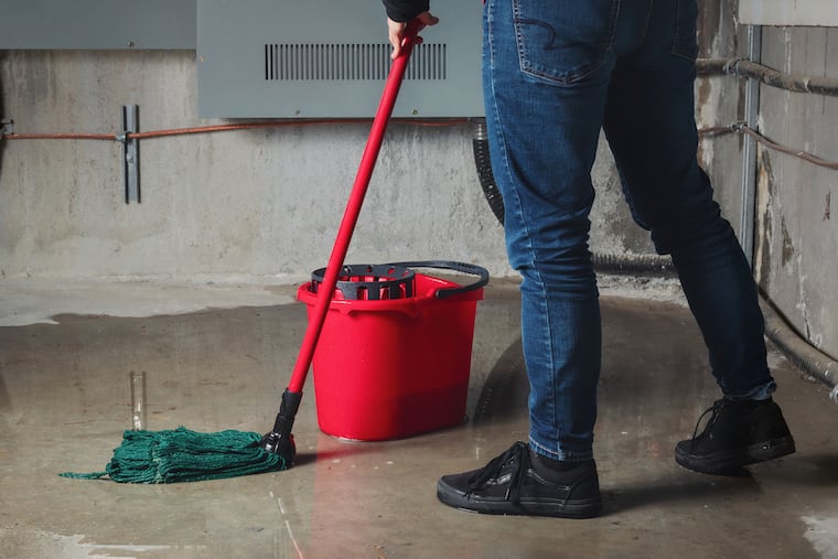 Water damage from rain, snowmelt or pipe burst coming from multiple cracks and leaks in concrete wall and ceiling. Selective focus.
