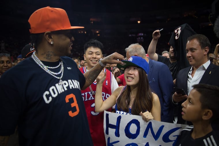Allen Iverson speaks with Ida Tsui and Adrian Wong, a couple from Hong Kong, who traveled to see him courtside at the BIG3 tournament at the Wells Fargo Center.