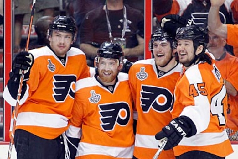 On June 4, 2010, Matt Carle (second right) celebrates his first-period goal with
teammates Claude Giroux, Arron Asham (right) and James van Riemsdyk (left)
against the Chicago Blackhawks in game four of the Stanley Cup Finals.