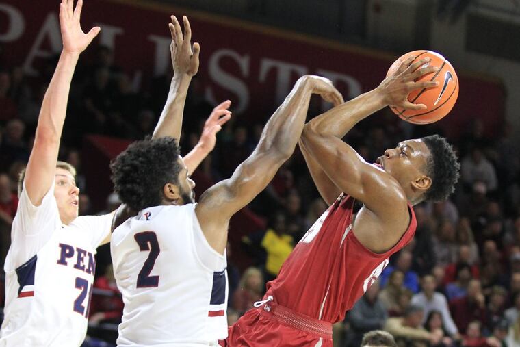 James Demery of Saint Joseph’s shooting over Penn defenders on Jan. 27.