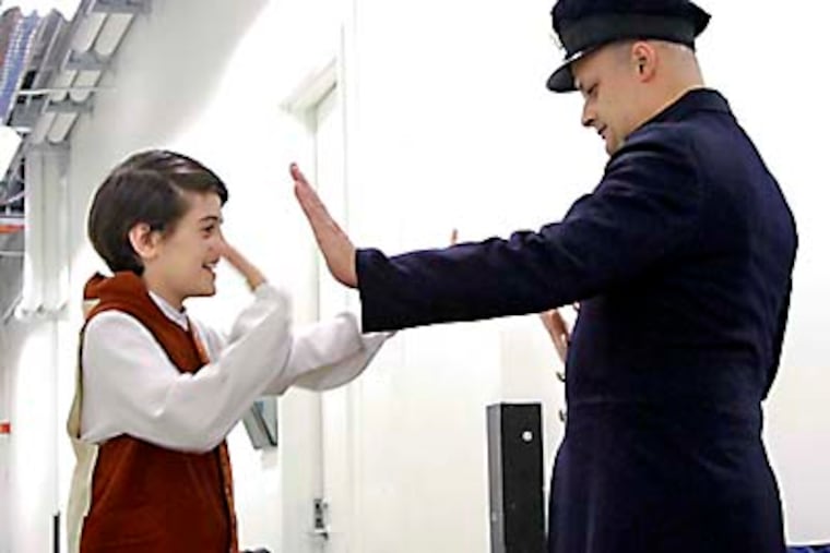 Before their performance Jake (left,son) and Scott Faragalli (dad) high five as they prepare for "A Stoop on Orchard Street" at the National Museum of Jewish History in Phila. on October 25, 2012. ( ELIZABETH ROBERTSON / Staff Photographer )