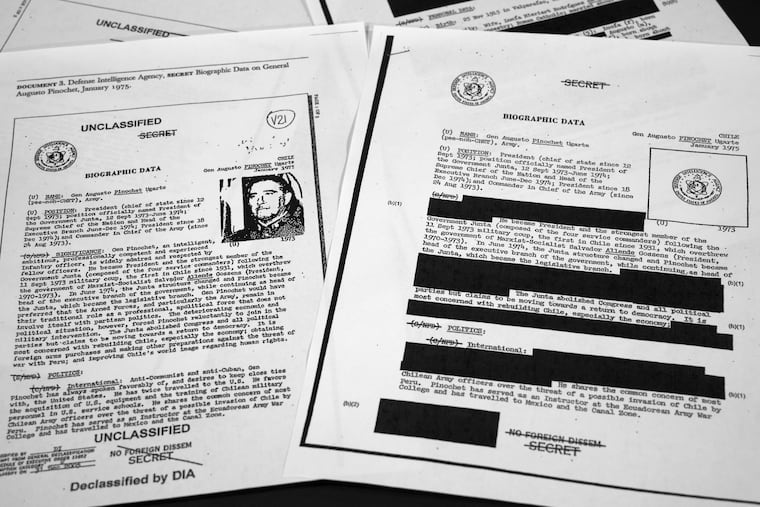The redacted, right, and the unredacted versions of the biographical intelligence file report on Chilean dictator Augusto Pinochet from 1975 is photographed on April 15, 2019, in Washington. The redacted version of Robert Mueller's findings has been released.
