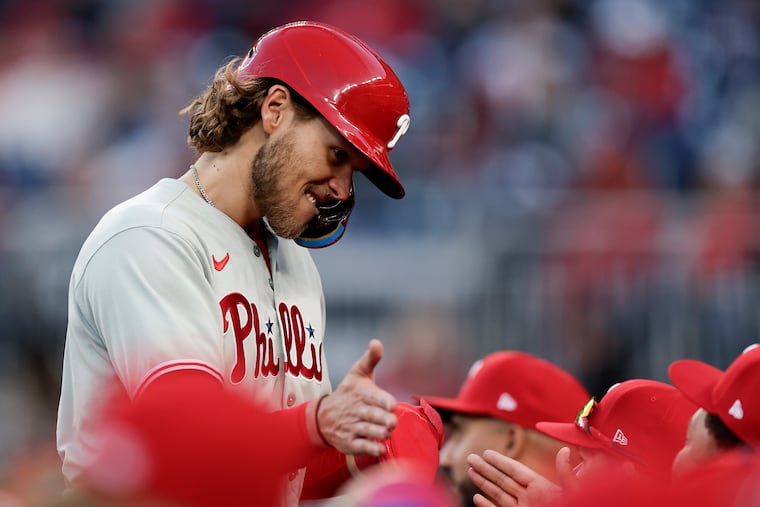 The Phillies' Alec Bohm celebrates his 10th-inning run with his teammates in their 7-3 win over the Nationals on Thursday in Washington, D.C.