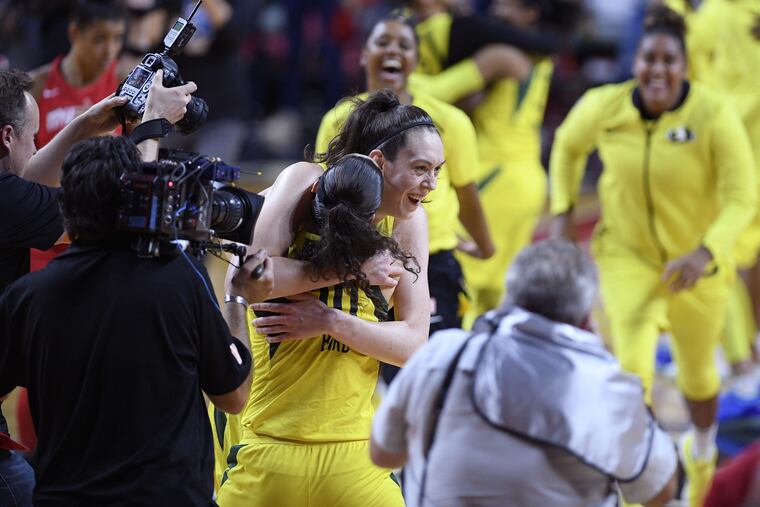 Breanna Stewart (back) celebrates with Sue Bird after the Storm beat the Mystics 98-82 to win the WNBA title.