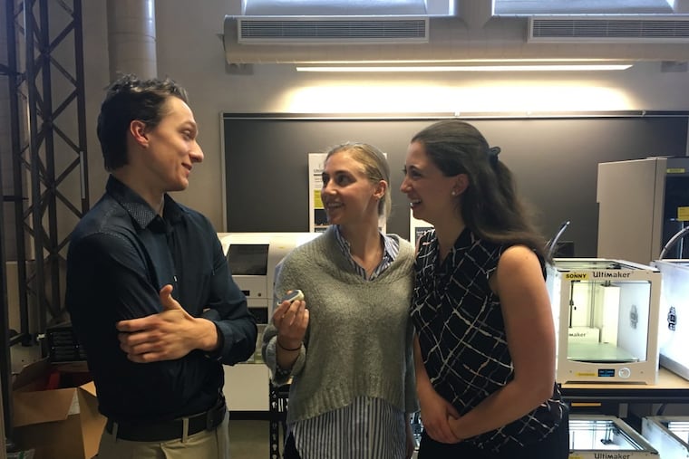 Lehigh University engineering students Chris Szafranski (left), Lena McDonnell (center) and Brooke Glassman talk about the device they created to improve safety for women, Soterra, which McDonnell is holding.