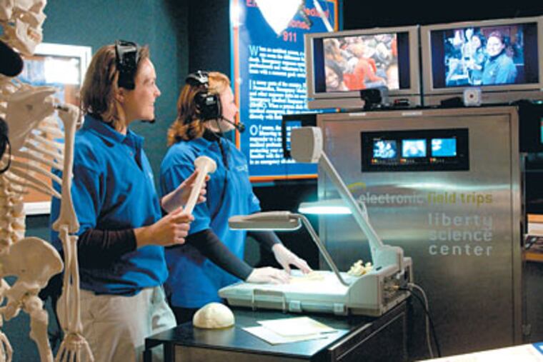 A cyber trip lets students "visit" the Liberty Science Center in Jersey City, N.J., via monitors. Such programs allow students to learn from the center's staff while districts save on busing.