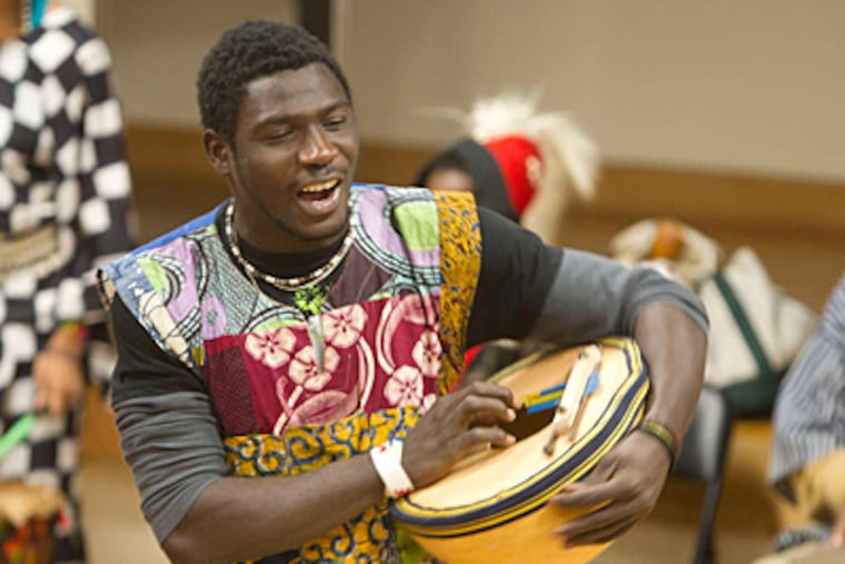 Camaro Facinet of Guinea performs with the Camara Arts and Baba Zumbi Soweto music group at the museum Saturday. (Ed Hille/Staff)