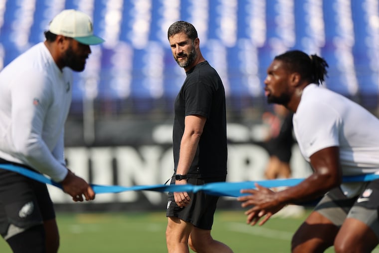 Nick Sirianni (center) watches as his team warm up before their preseason game against the Ravens on Saturday.