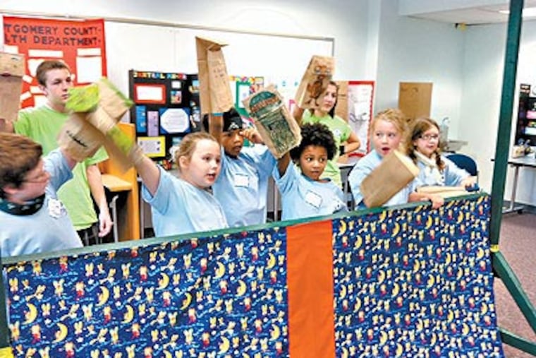 A group of children rehearse a puppet show. They are attending Abington Memorial Hospital's Camp Charlie, which is for children who have lost a parent. (Juliana Schatz / Staff)
