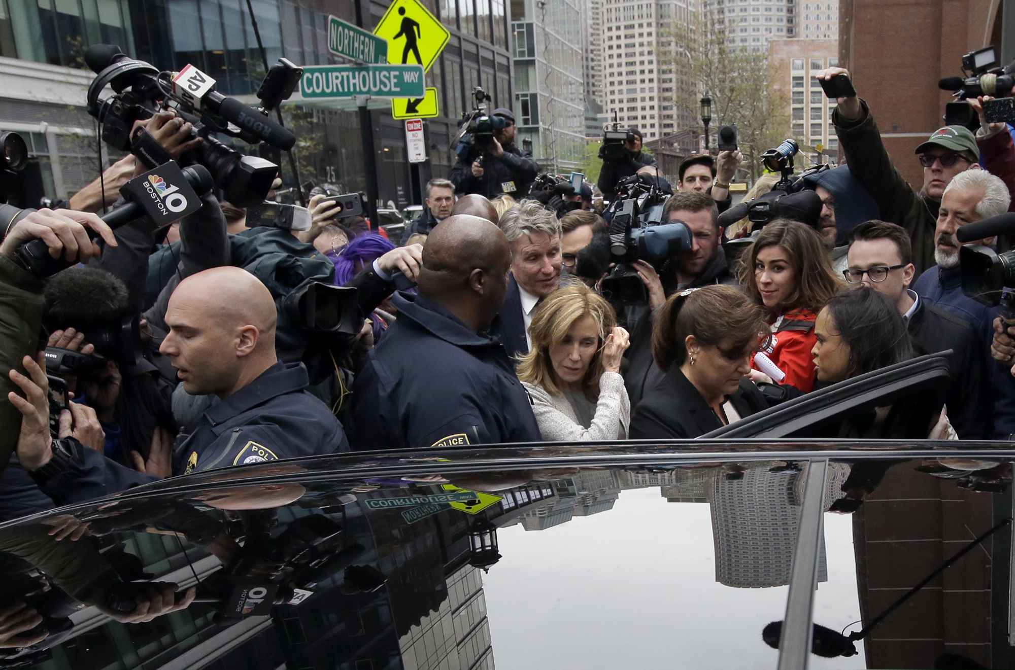 Felicity Huffman, center, gets into a vehicle followed by her brother Moore Huffman Jr., outside federal, Monday, May 13, 2019, in Boston, where she pleaded guilty to charges in a nationwide college admissions bribery scandal. Art imitates life, writes George Will, in a summer novel about the hyper-competitive world of elite college admissions.