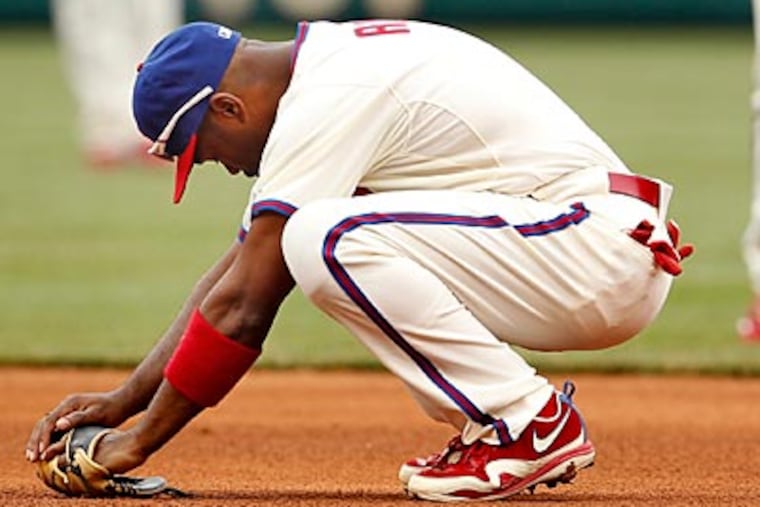 Jimmy Rollins reacts after it was ruled he missed the tag on Elvis Andrus' steal. (Ron Cortes/Staff Photographer)