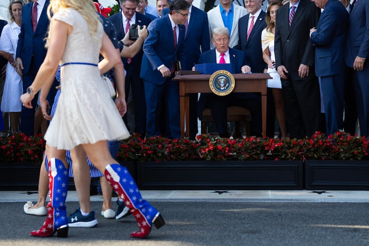 President Donald Trump signs the One Big Beautiful Bill on July 4 at the White House. MUST CREDIT: Tom Brenner/For The Washington Post