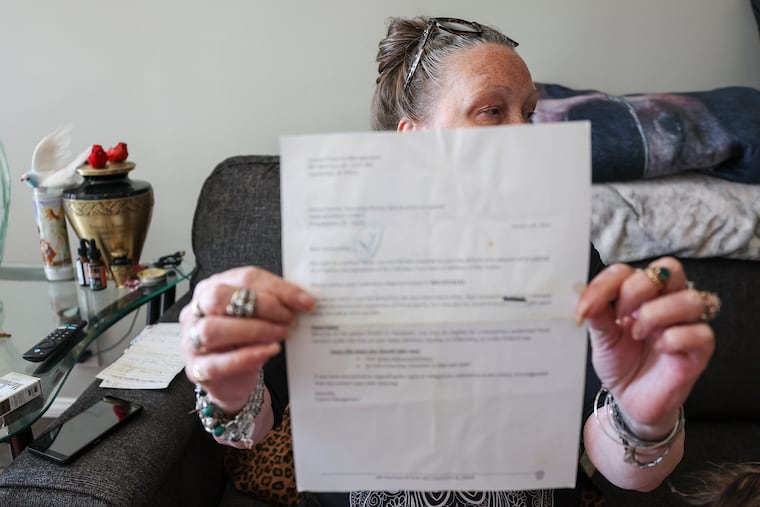 Donna Kuzowsky holds up a notice that was taped on her door last year in Mayfair. Philadelphia may lead the way with its Eviction Diversion Program, but tenants who are evicted illegally typically deal with landlord-tenant issues in the shadows.