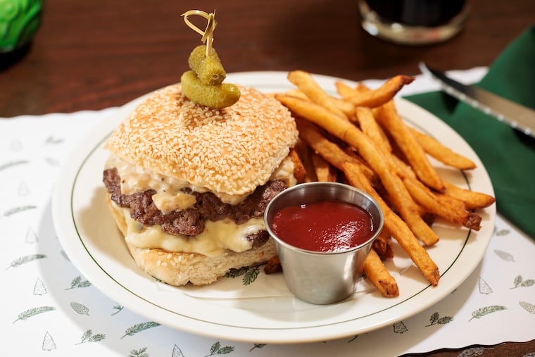 The PSG burger with Cooper Sharp, onion condiment, and a seeded Martin’s bun at Pine Street Grill.