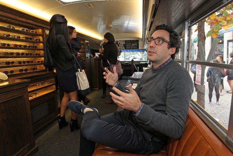 Neil Blumenthal, one of the co-founders of Warby Parker, talks about his business vision aboard the tour bus. The brand, which was founded by four Wharton students, is "trying to radically transform the optical industry," said Blumenthal. ( MICHAEL BRYANT / Staff Photographer )