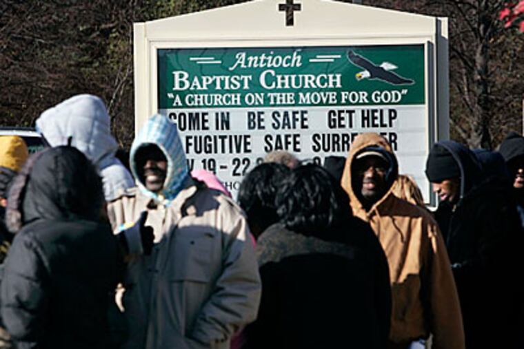 People line up at the Antioch Baptist Church to turn themselves in under the Camden Safe Surrender program for fugitives on Saturday morning. (Laurence Kesterson / Inquirer)