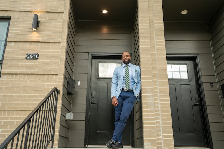 Eric Murchison, 35, on the front steps of his new East Falls townhouse.
