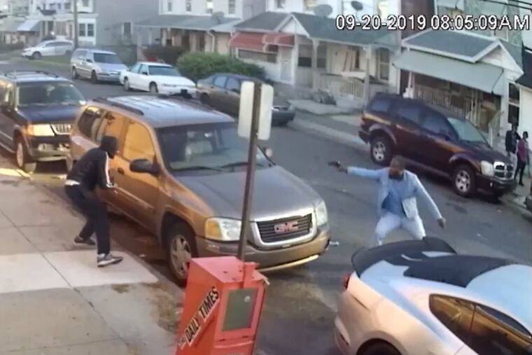 Image from surveillance video shows two men engaged in a gun battle Friday morning near Chester High School in Delaware County.