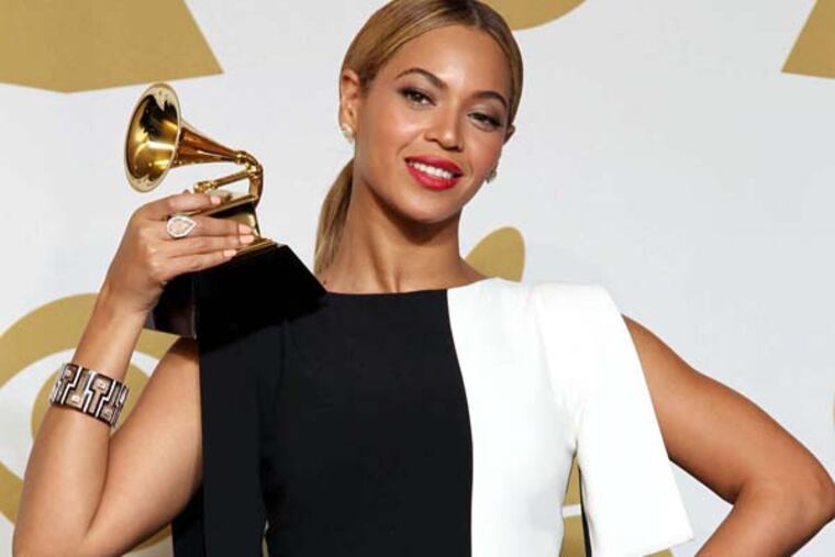 Beyonce poses backstage with the award for best traditional R&B performance for "Love on Top" at the 55th annual Grammy Awards on Sunday, Feb. 10, 2013, in Los Angeles. (Photo by Matt Sayles/Invision/AP)