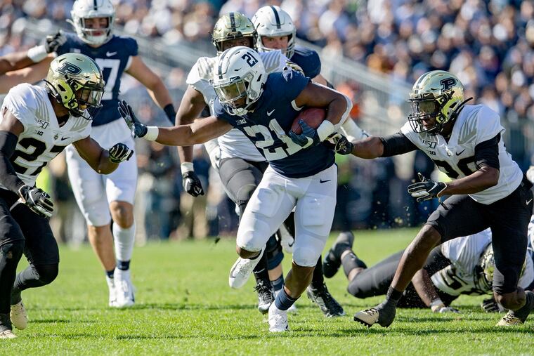 Purdue defenders converge on Penn State running back Noah Cain (21).