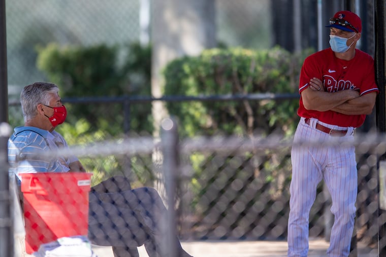 Phillies president of baseball operations Dave Dombrowski, left, chats with manager Joe Girardi during a spring-training workout in Clearwater, Fla.