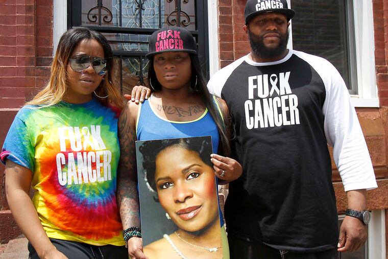 Makia Underwood (left), sister Zakia Clark, and uncle Curran Underwood wear anticancer gear in honor of their late mother. They were escorted from the King of Prussia mall because of the wording.