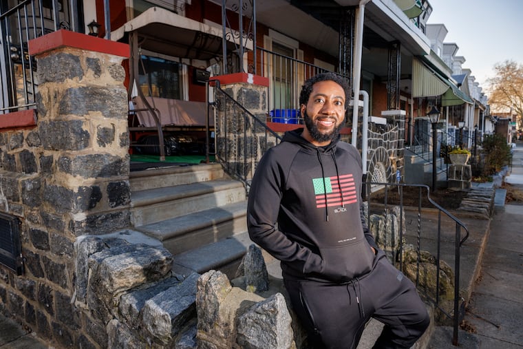 Trey Barnes in front of the duplex he purchased in West Philadelphia as a first-time home buyer in 2022.