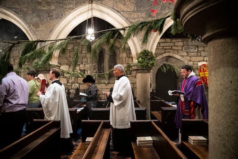 John Hager, Randall Jefferson, and Rev. Andrew Kellner process toward down the aisle before mass at the Church of St. James the Less in North Philadelphia. The historically and architecturally significant church and its school have rebounded in the last decade.