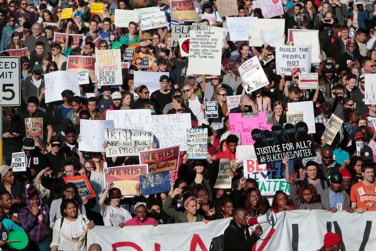 Marchers fill a downtown street in Madison, Wis., as they protest the police killing of Tony Robinson.