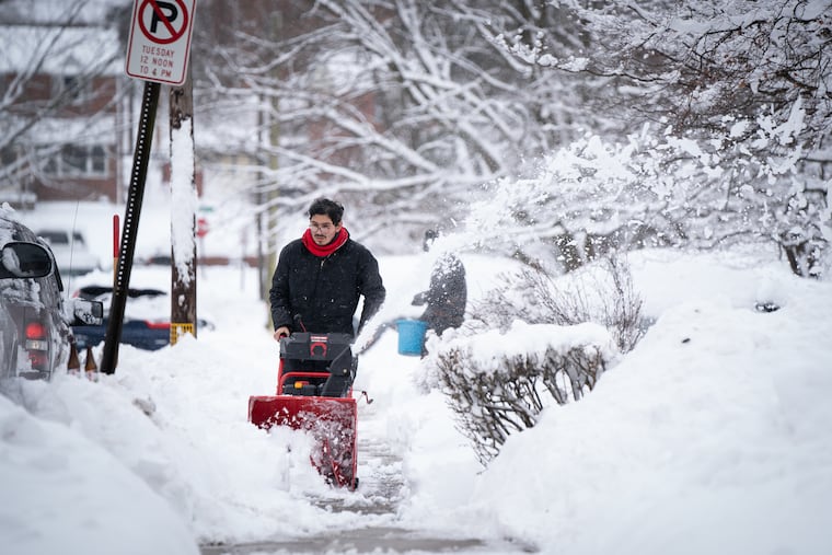 Andres Lopez clears the sidewalk in Norristown on Groundhog Day. He'll probably need that thing Thursday and Friday.