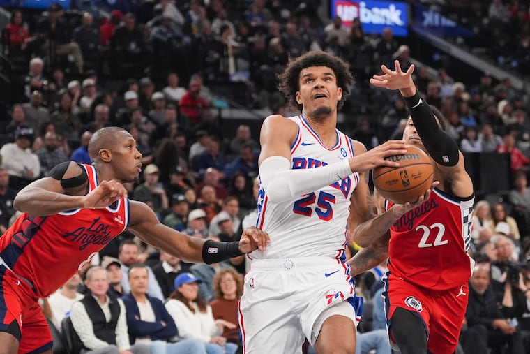 Sixers forward Dominick Barlow drives to the basket past the Clippers' Kris Dunn (left) and Jordan Miller.
