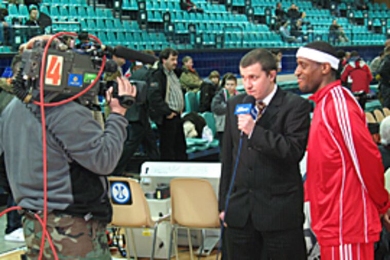 Rashid Atkins interviewed on Polish television before a game. Atkins, who starred at St. Joseph's, plays on a team in Poland with fellow Philadelphian, Dawan Robinson. (Mike Jensen / Inquirer)