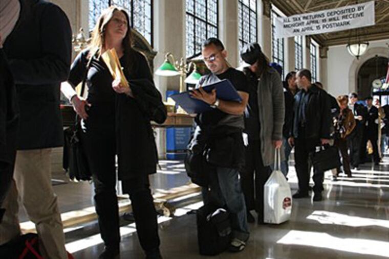 FILE - In this April, 15, 2008, file photo, Jackie Doyle, of Greenwood Lake, N.Y., second from left, waits in line to mail her husband's taxes at the James A. Farley Main Post Office in New York. The package of tax increases and spending cuts known as the “fiscal cliff” takes effect on January 1, 2013, unless Congress passes a budget deal by then. The economy would be hit so hard that it would likely sink into recession in the first half of 2013, economists say. (AP Photo/Tina Fineberg, File)