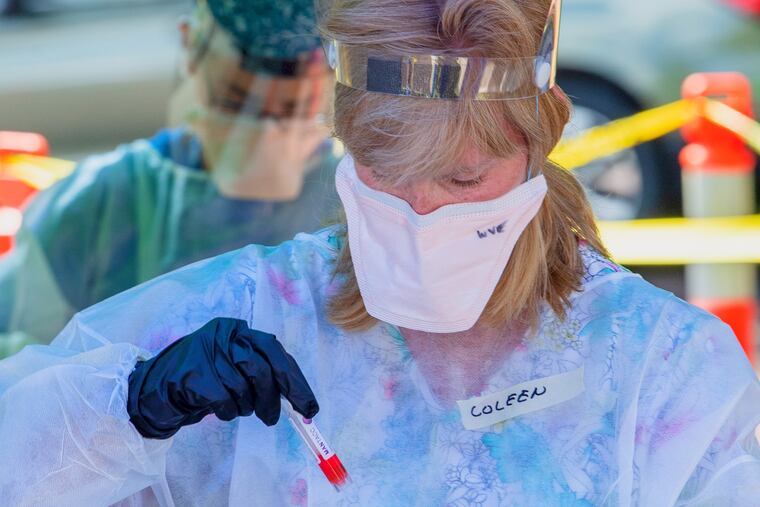 Volunteers test Delaware County residents for the coronavirus on July 9 at the Providence Rehabilitation & Healthcare Center on the Mercy Fitzgerald Campus in Yeadon.