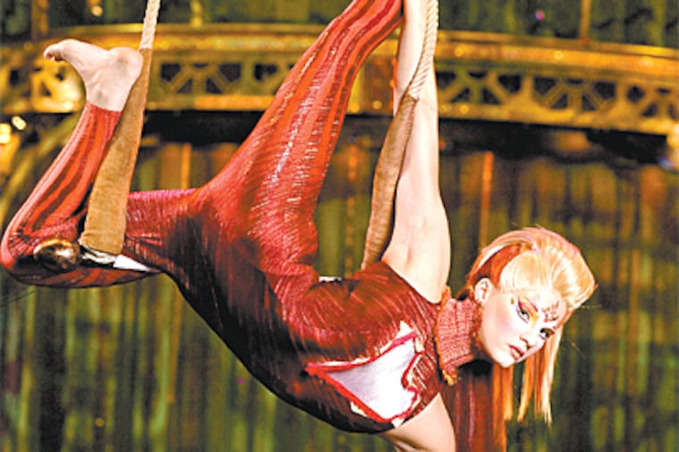A Cirque du Soleil performer does her trapeze act in "Kooza," playing in the company's big tent on South Broad Street.