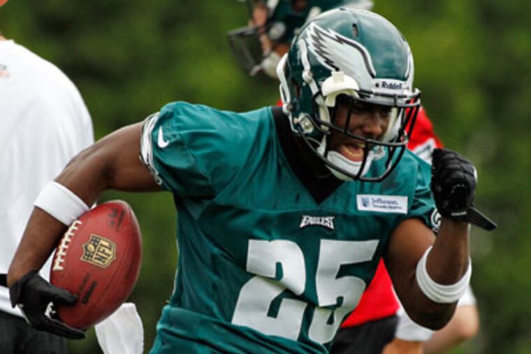 LeSean McCoy runs with the ball curing the Eagles' first day of OTAs. (AP Photo/Alex Brandon)