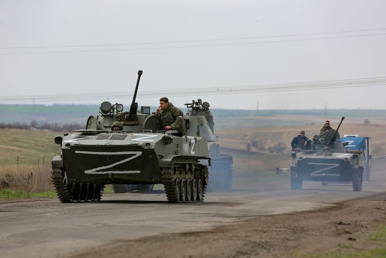 Russian military vehicles move on a highway in an area controlled by Russian-backed separatist forces near Mariupol, Ukraine, on Monday.