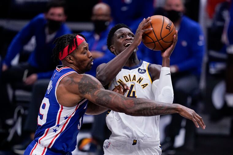 The Pacers' Victor Oladipo (4) is fouled by the Sixers' Dwight Howard (39) as he goes up for a shot during the second half of Friday's preseason finale in Indiana.