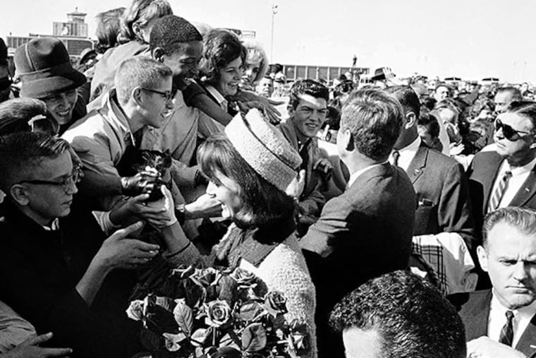In this Nov. 22, 1963 file photo, President John F. Kennedy and first lady Jacqueline Kennedy greet people on their arrival at the Dallas Airport (Love Field). (AP Photo/HWB, File)