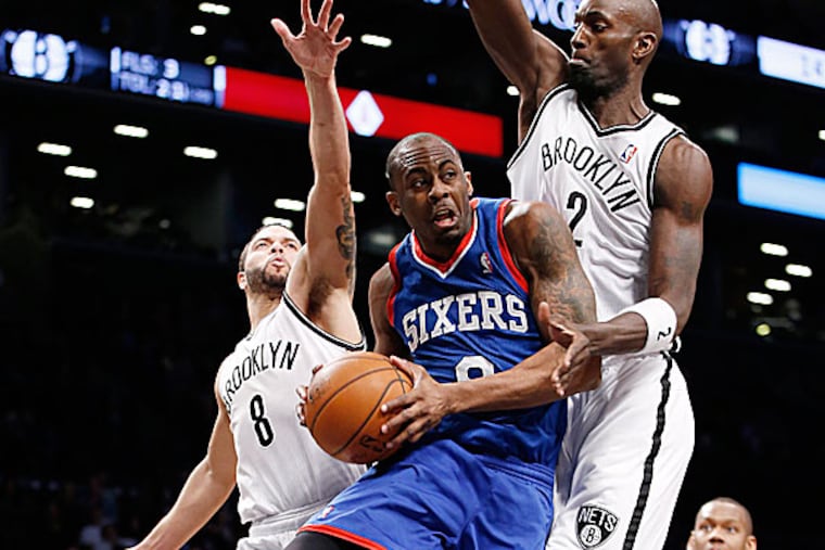 Nets guard Deron Williams and forward Kevin Garnett defend 76ers guard James Anderson. (Kathy Willens/AP)