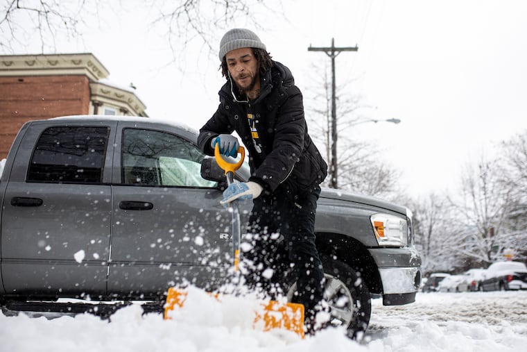 Mac Nickelz, 33, of West Philadelphia, shovels a fellow neighbors sidewalk along Larchwood Ave, in West Philadelphia, Pa., on Tuesday, Feb. 2, 2021. Nickelz lives along Larchwood Ave and has been shoveling homes since he was 13.
