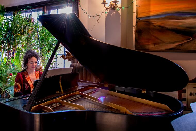 Composer Andrea Clearfield playing piano at home in Philly.