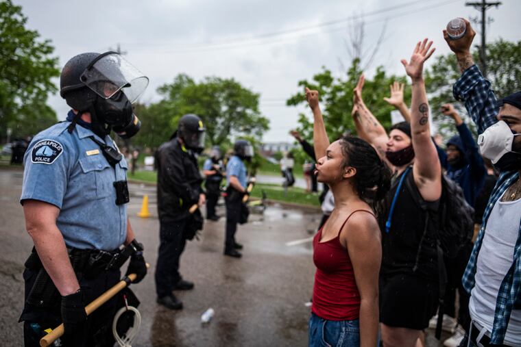 Protesters and police faced each other during a rally for George Floyd in Minneapolis on Tuesday.