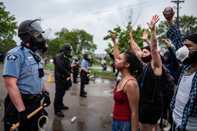Protesters and police face each other during a rally for George Floyd in Minneapolis on May 26, 2020.